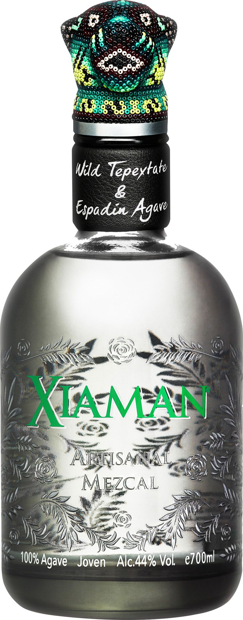 Eine Flasche mit einer silbernen und grünen Verpackung. Die Flasche hat einen auffälligen Deckel mit einem bunten Design. Auf dem Etikett steht der Name in grüner Schrift.