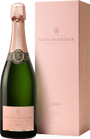Eine Flasche Champagner steht neben einer eleganten, rosa Verpackung. Die Flasche hat eine grüne Glasfarbe und einen dekorativen Verschluss, die Verpackung ist schlicht und luxuriös gestaltet.