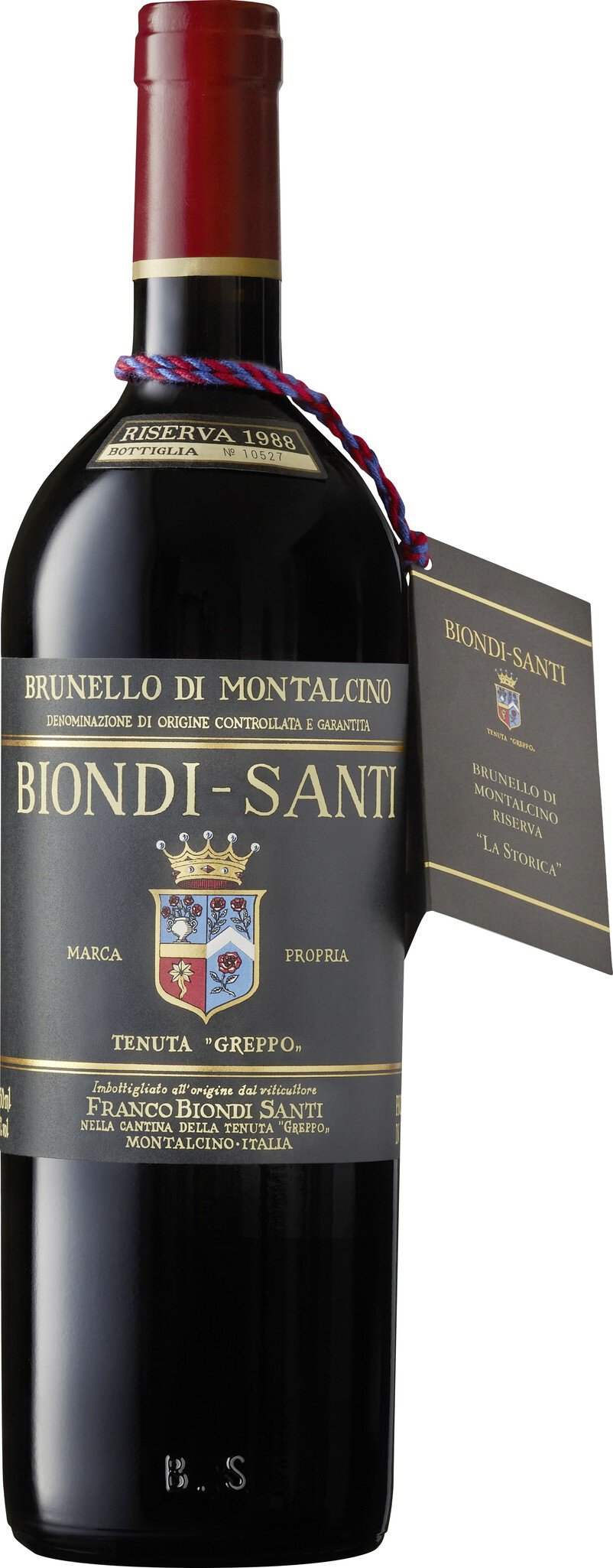 Eine Flasche Rotwein mit schwarzer Etikettierung und goldenen Schriftzügen. Sie trägt den Namen -Brunello di Montalcino- von Biondi-Santi und ist als Riserva 1988 gekennzeichnet. Ein Anhänger mit weiteren Informationen ist angebracht.
